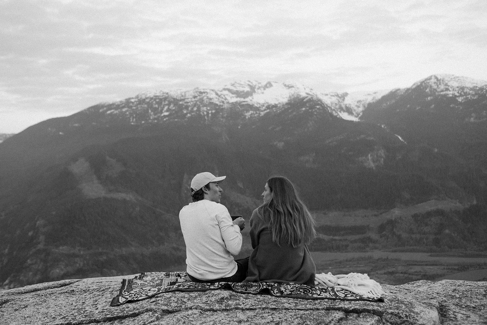 Couple sitting on a mountain together